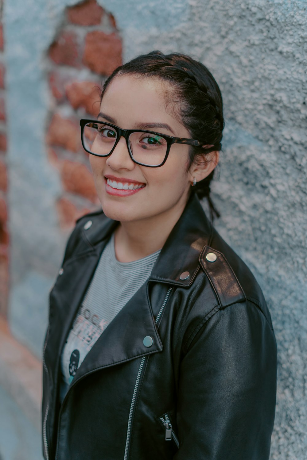 woman in black leather jacket wearing black framed eyeglasses