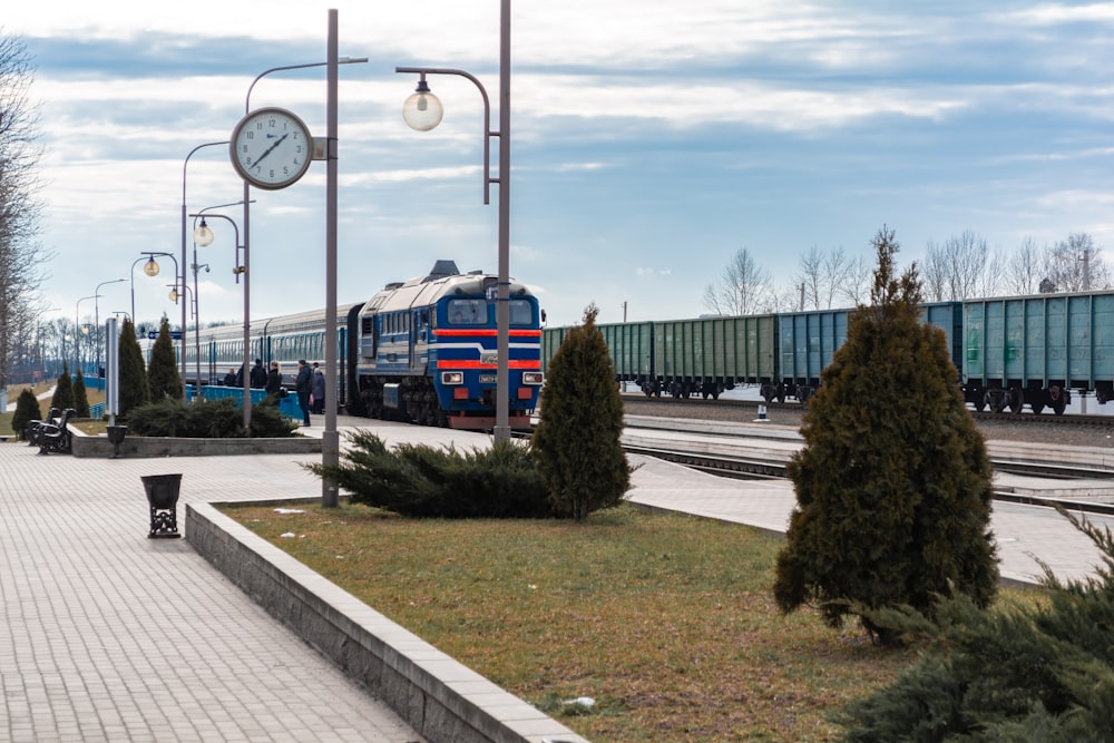 blue red and yellow train on rail road during daytime