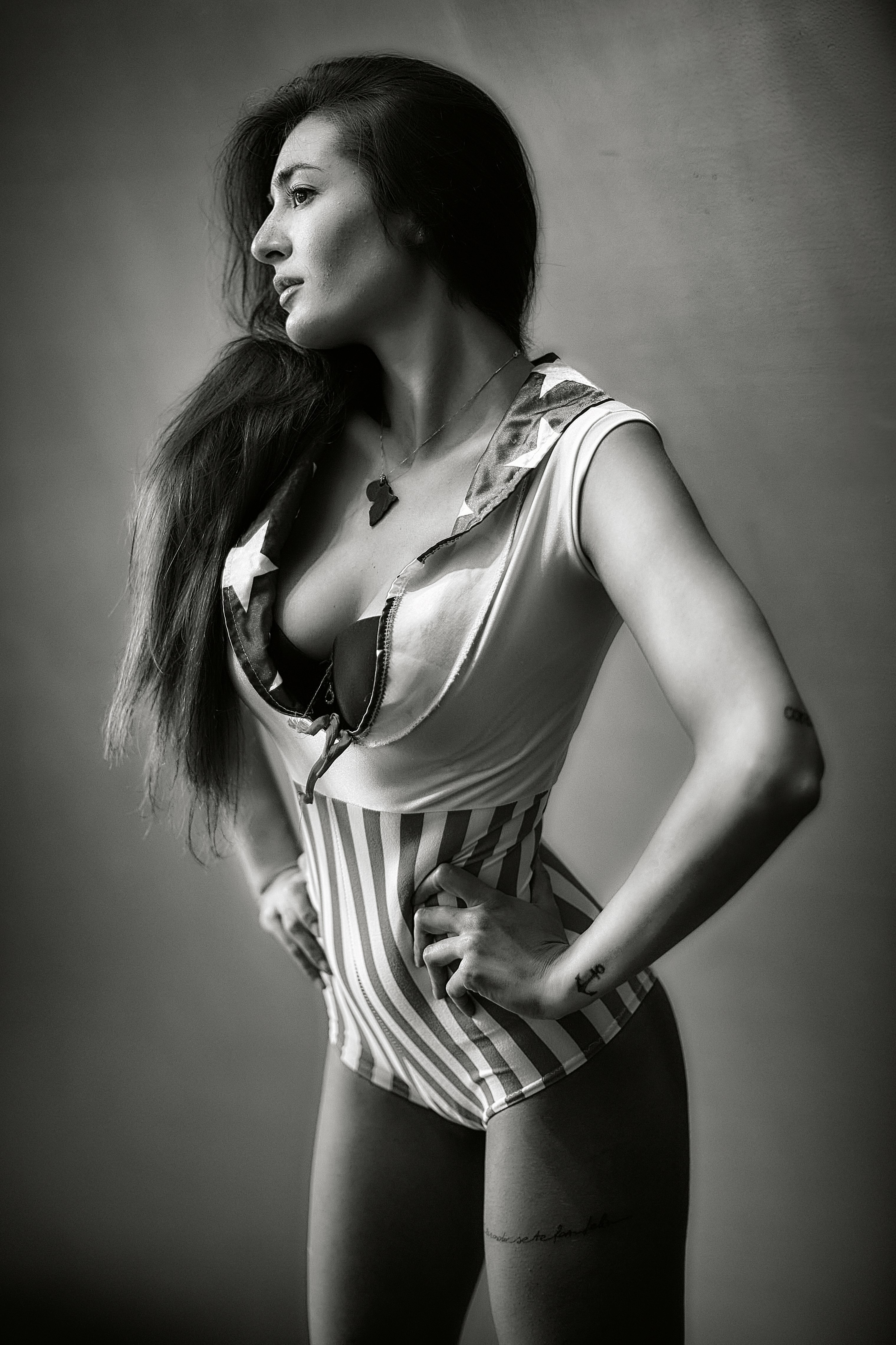 woman in black and white stripe spaghetti strap dress