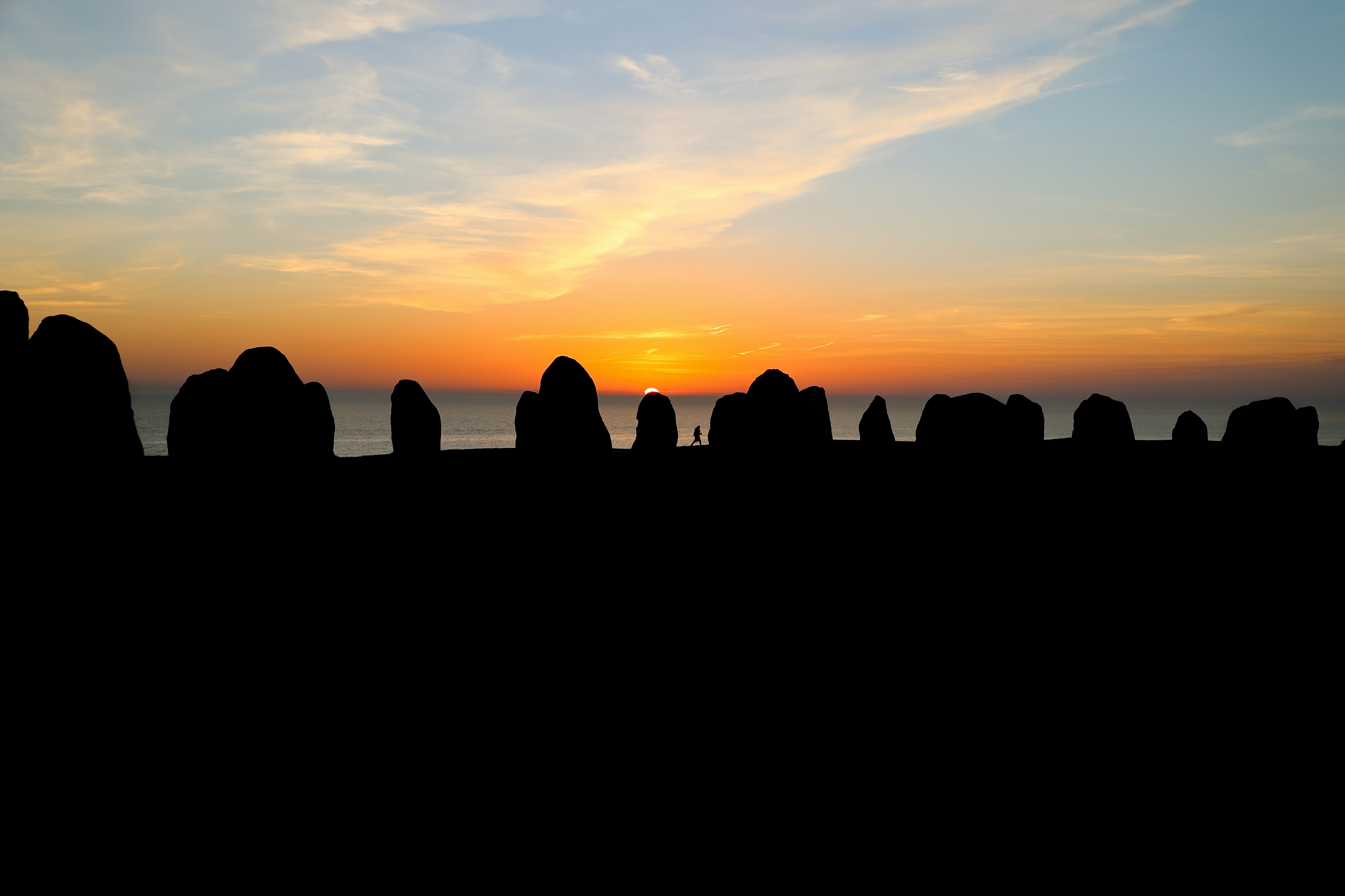 silhouette of rocks during sunset
