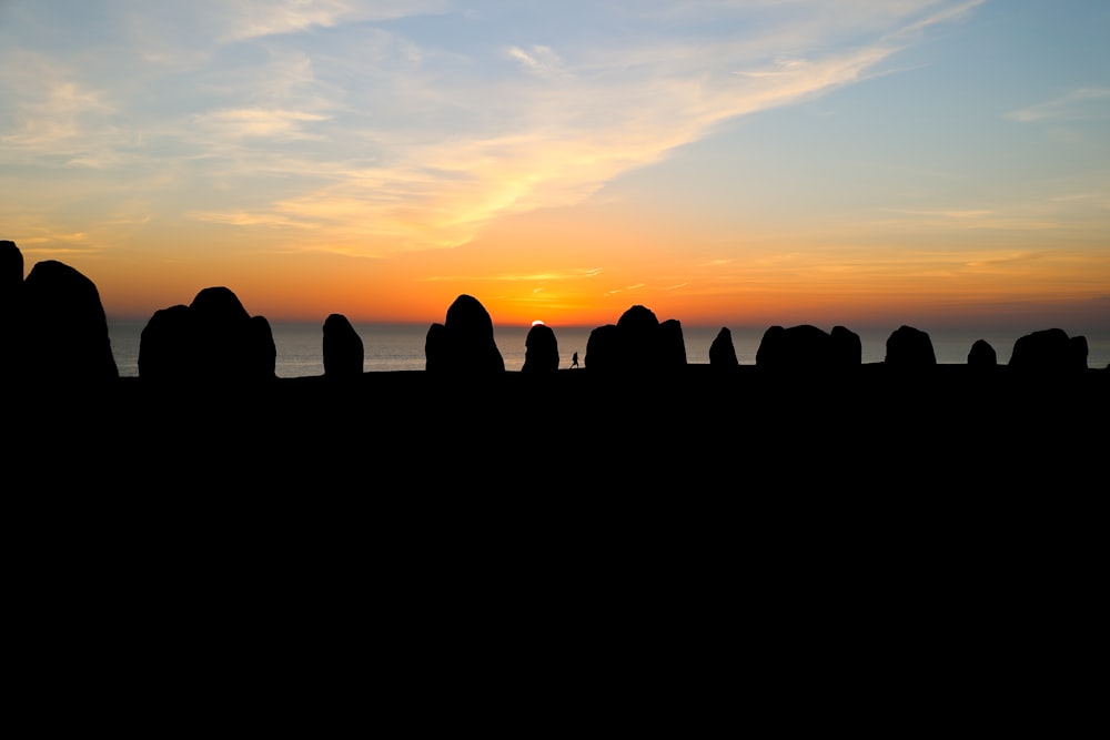 silhouette of rocks during sunset