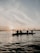 A group of friends enjoying a sunset kayak trip through the winding waterways of the Ebro Delta.