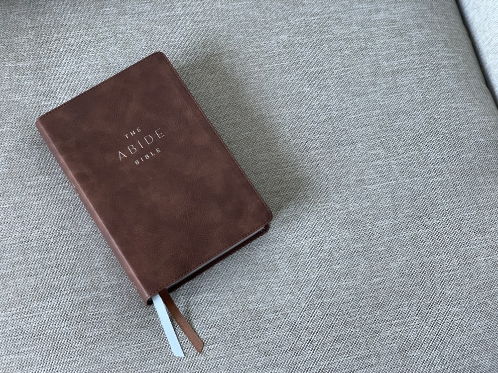 red book on gray textile