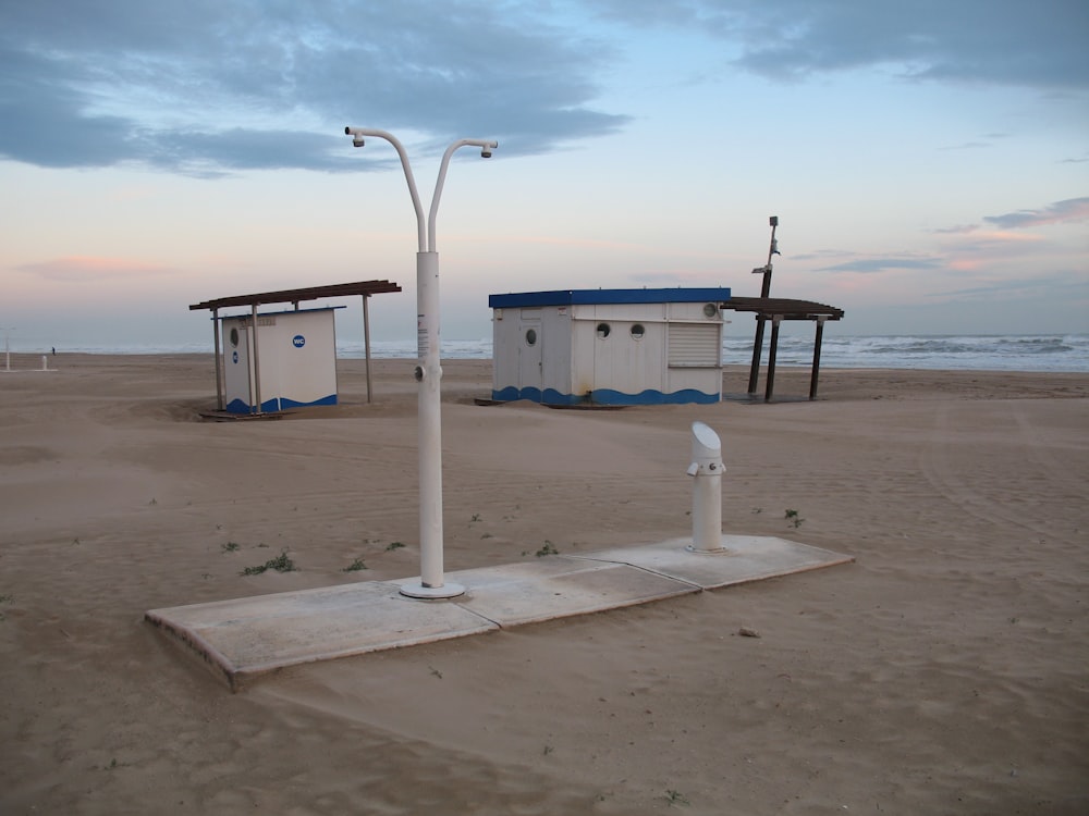 white and blue lifeguard tower on beach during daytime