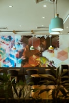 A vibrant café interior with colorful CNC printed wall art creating a welcoming atmosphere.