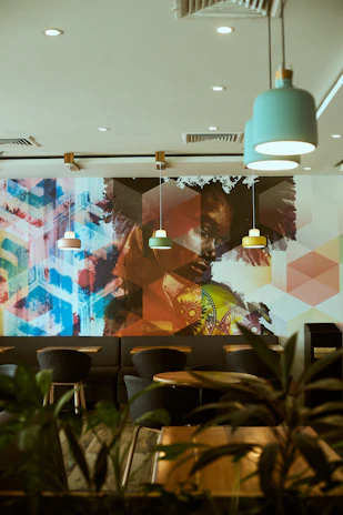 Vibrant café interior showcasing a colorful 3D mural wallpaper that energizes the space.