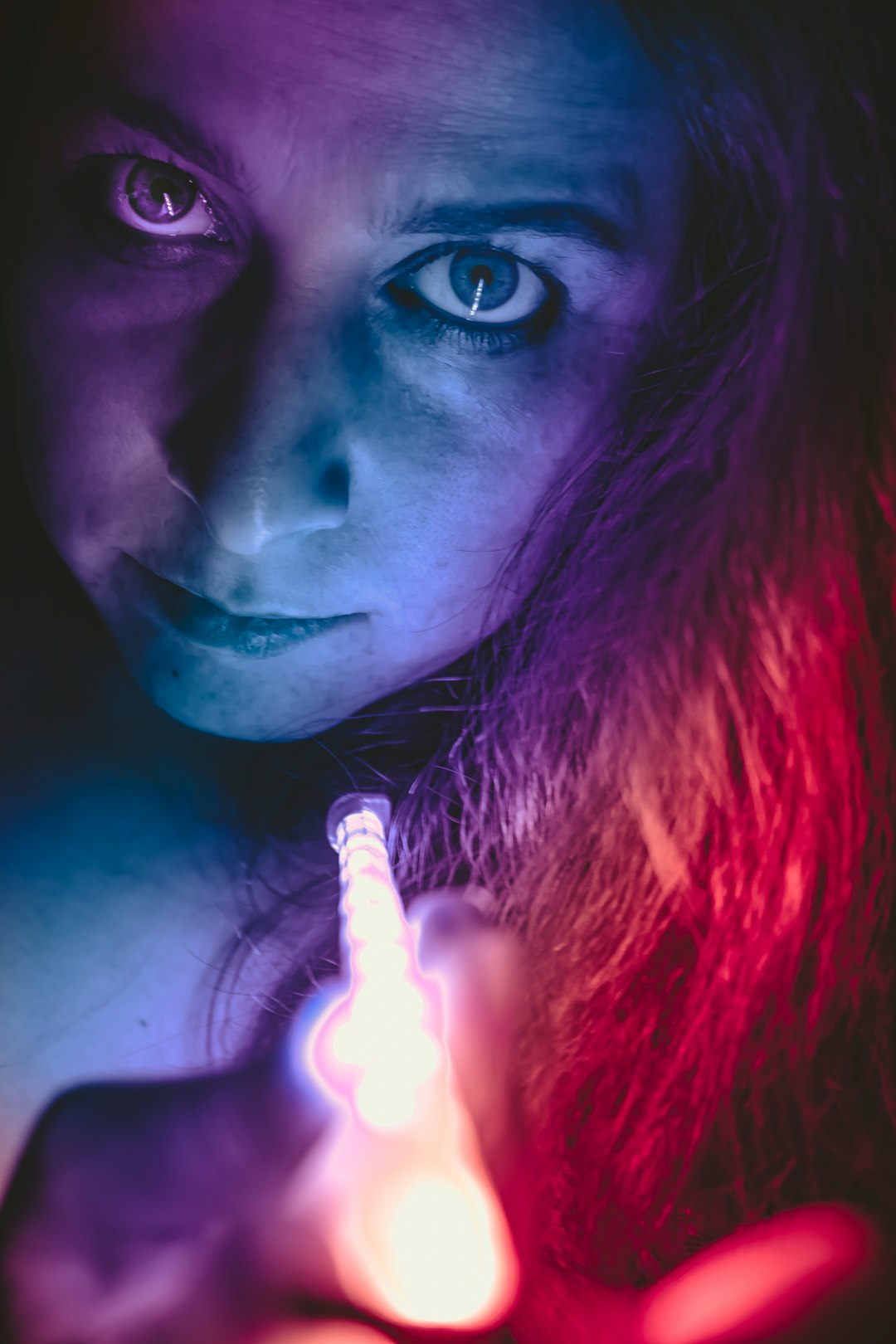 woman with red hair holding white cigarette stick