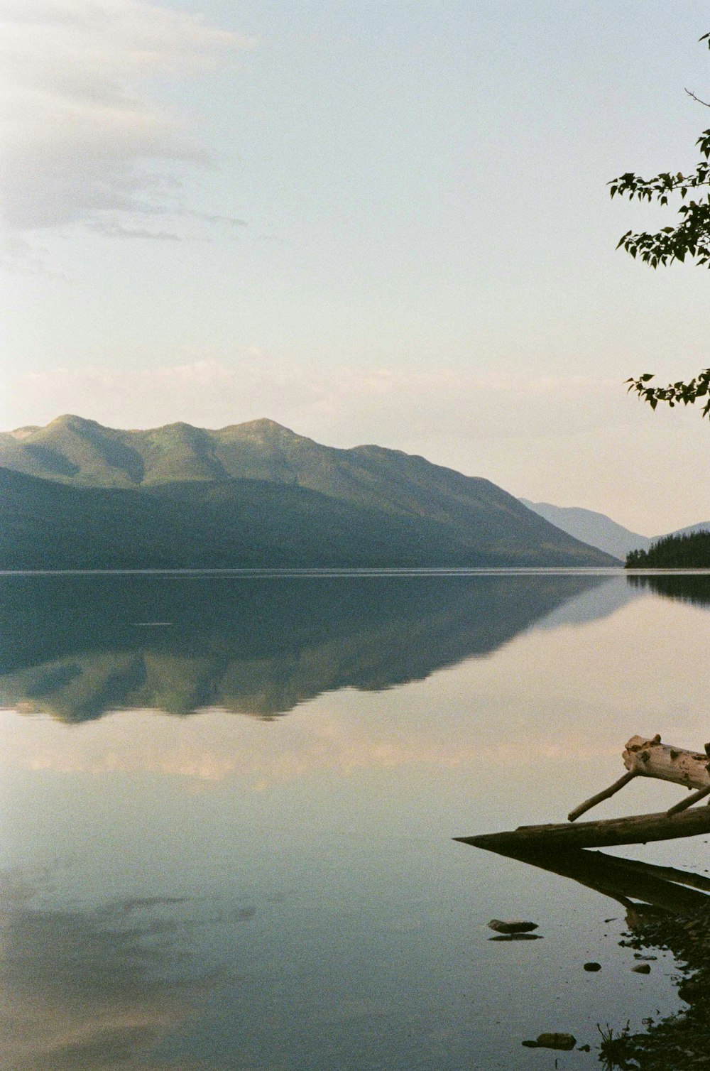 man sitting on brown wooden boat on lake during daytime