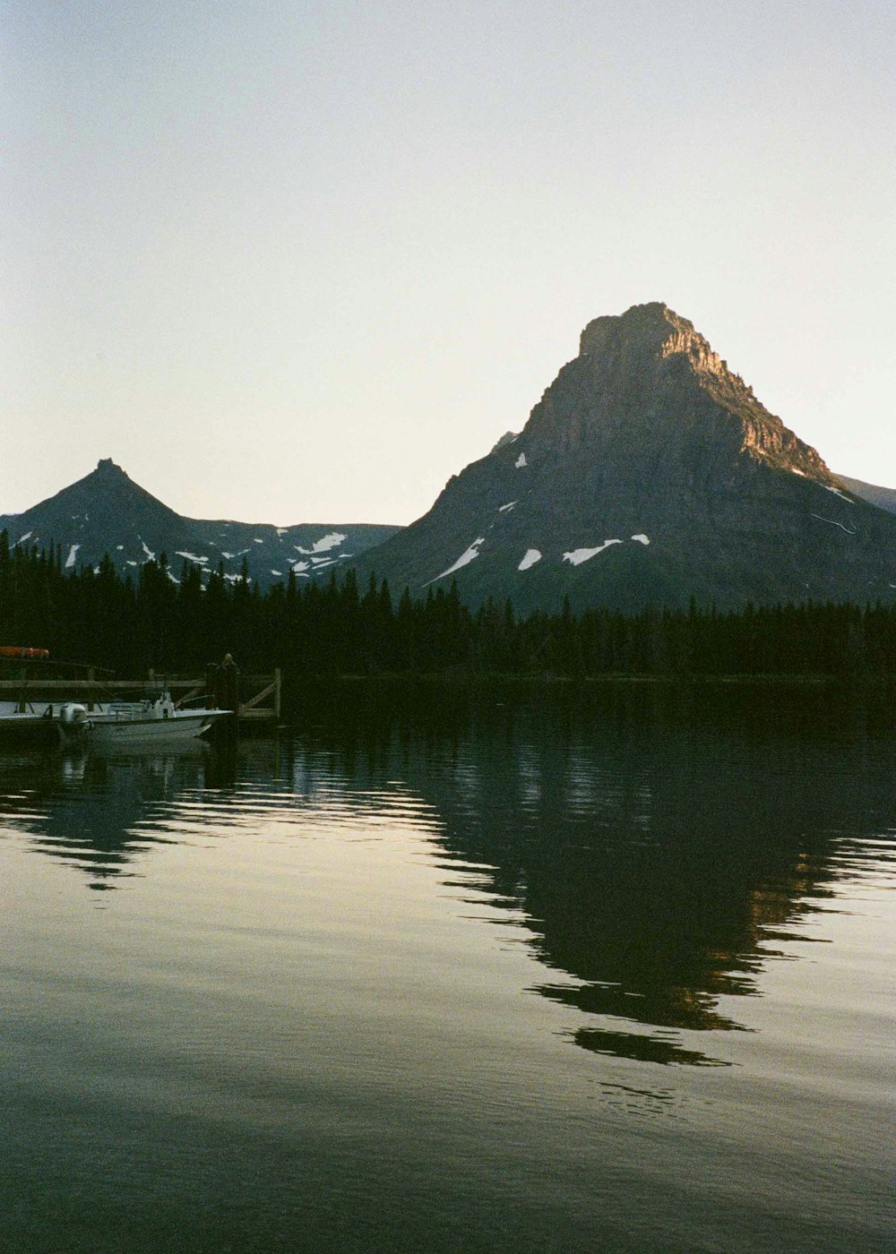 body of water near mountain during daytime