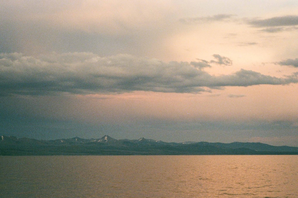 body of water under cloudy sky during daytime