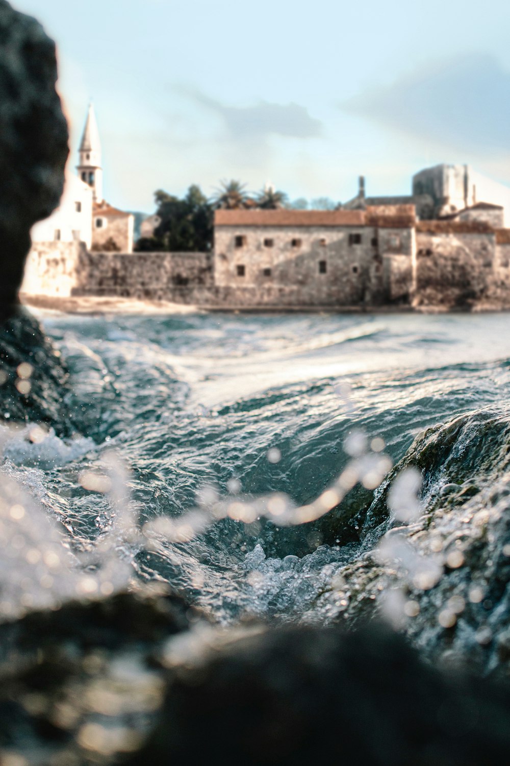 water splash on brown concrete building during daytime