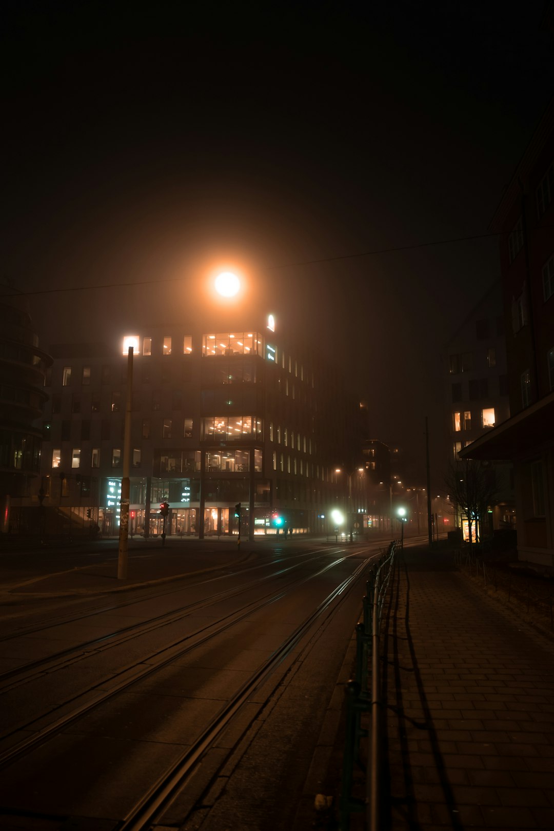 lighted street lights on road during night time