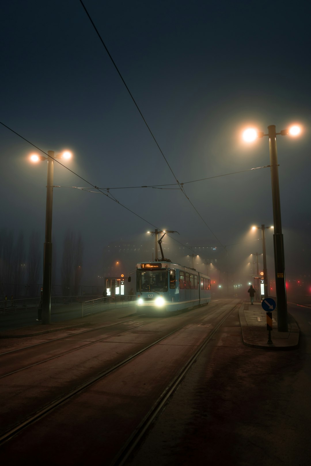 red and white train on rail during night time