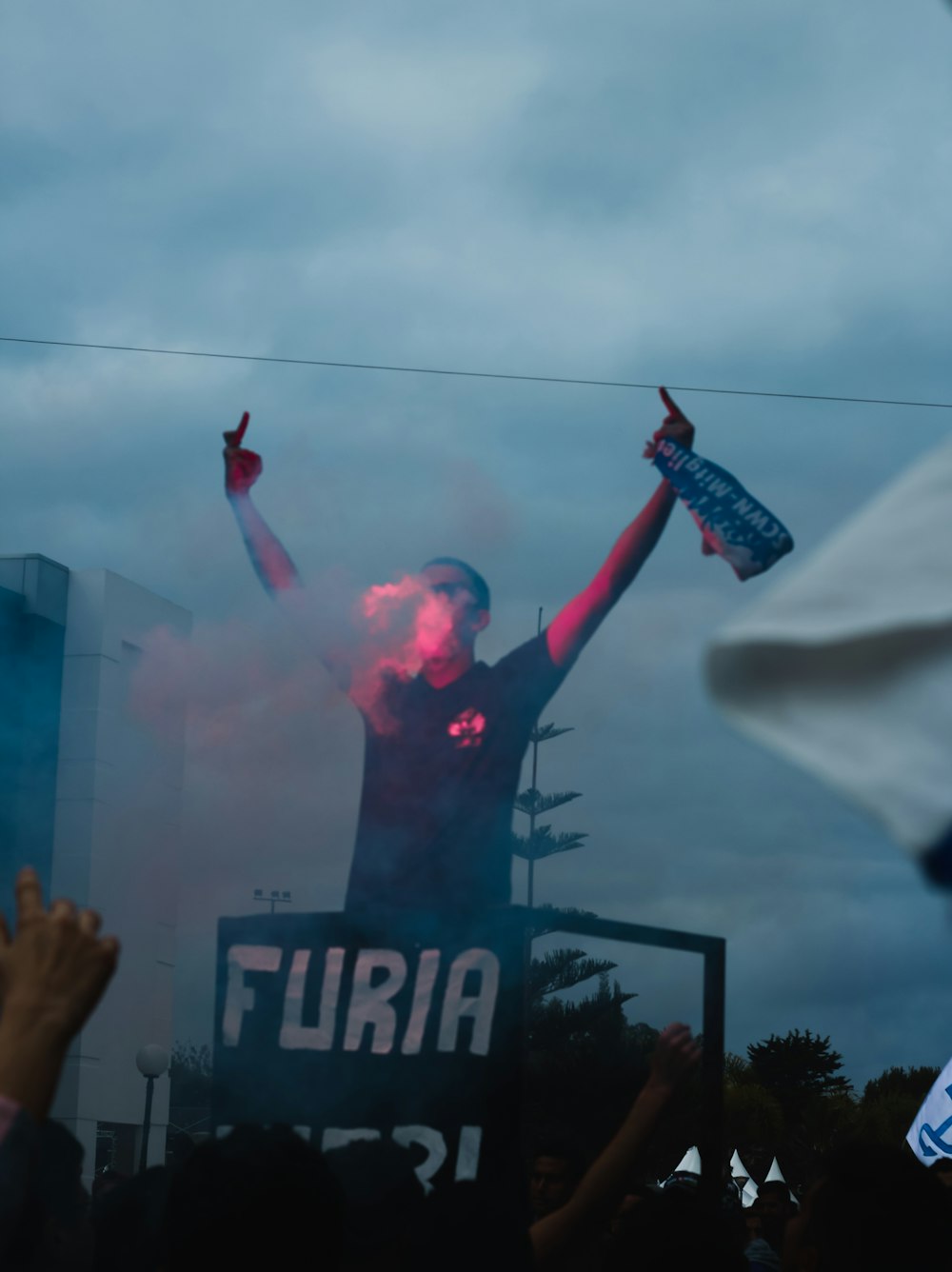 man in black and red jersey shirt holding red and white plastic pack