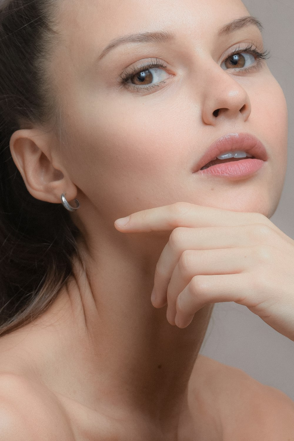 woman with silver stud earring