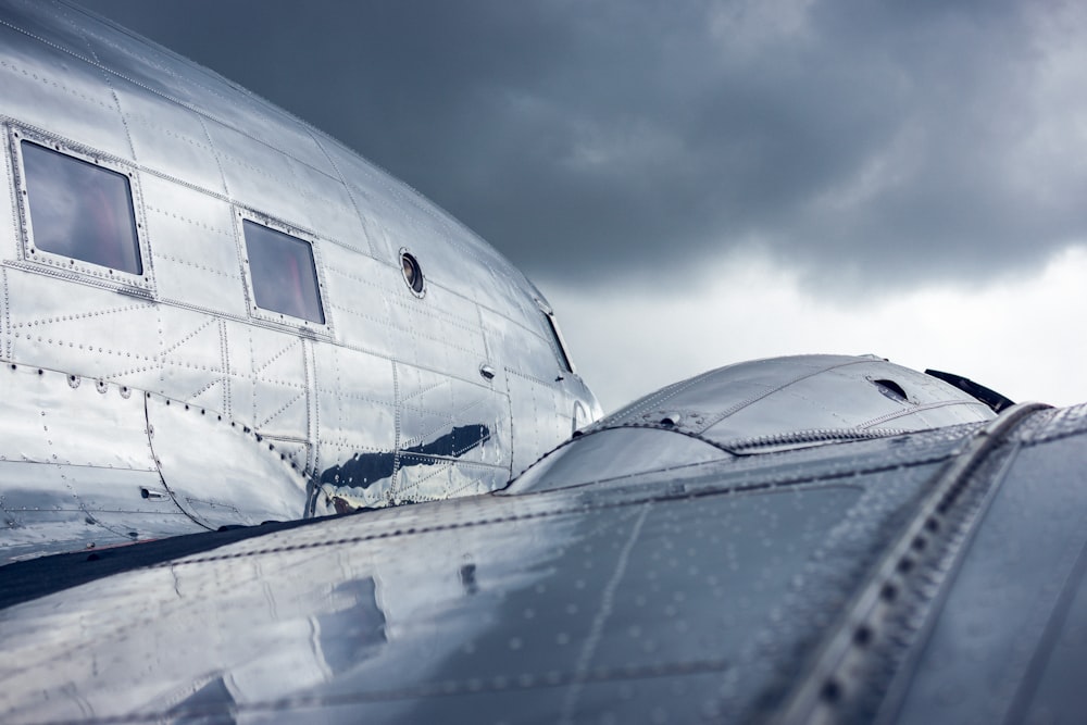 white airplane under cloudy sky during daytime