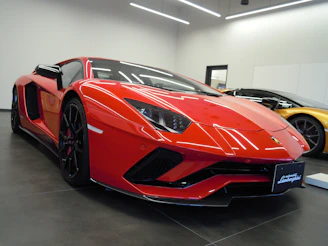 A vibrant red sports car gleaming on the showroom floor, capturing attention with its bold lines.