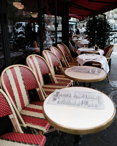 A cozy Paris bistro dining room with close-set tables, typical of a neighborhood wine bistro