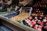 Close-up of fresh fruits neatly arranged on a wooden market stall.