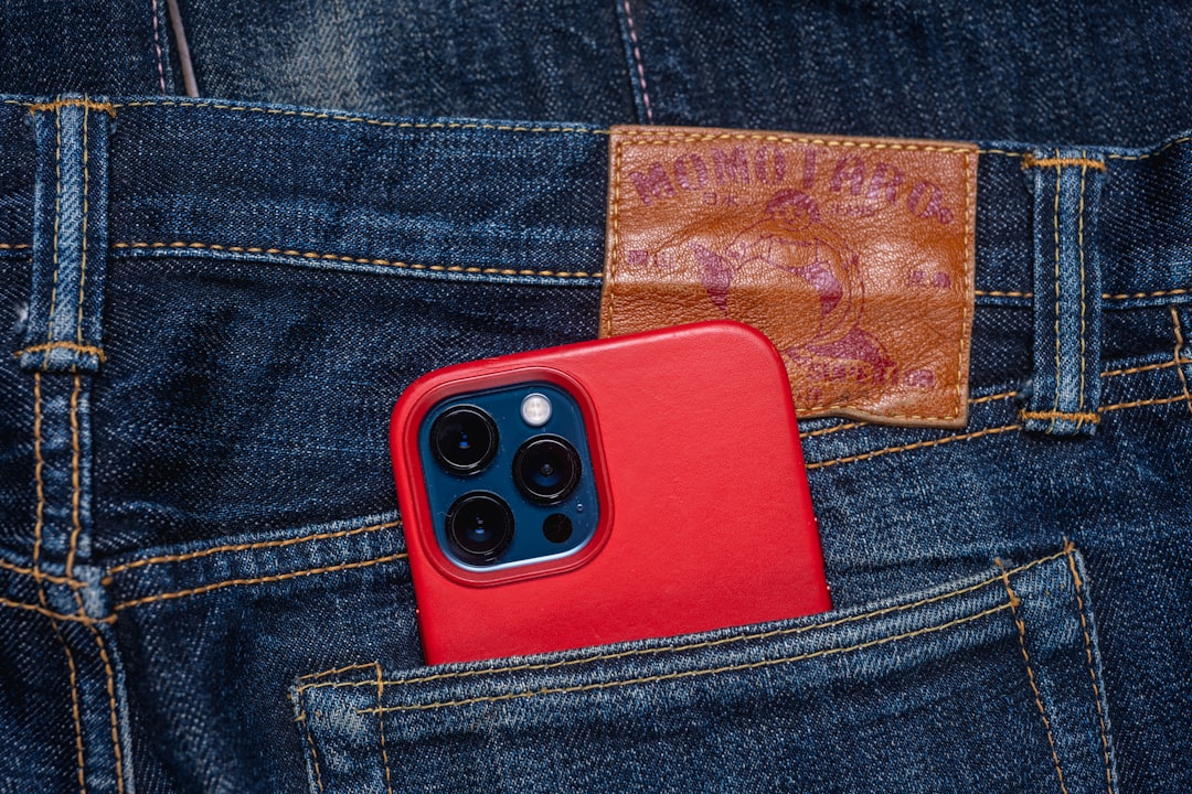 red and black remote control on blue denim jeans