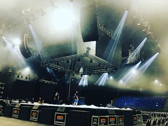 Professional audio and lighting setup being installed at a vibrant event venue.