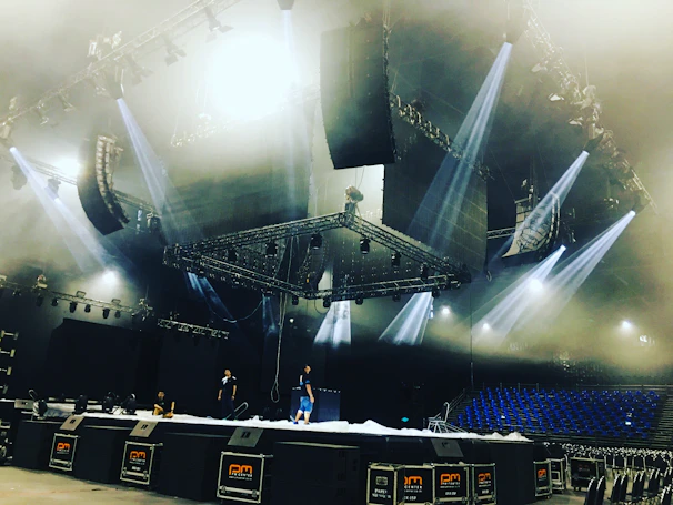 Professional audio and lighting setup being installed at a vibrant event venue.