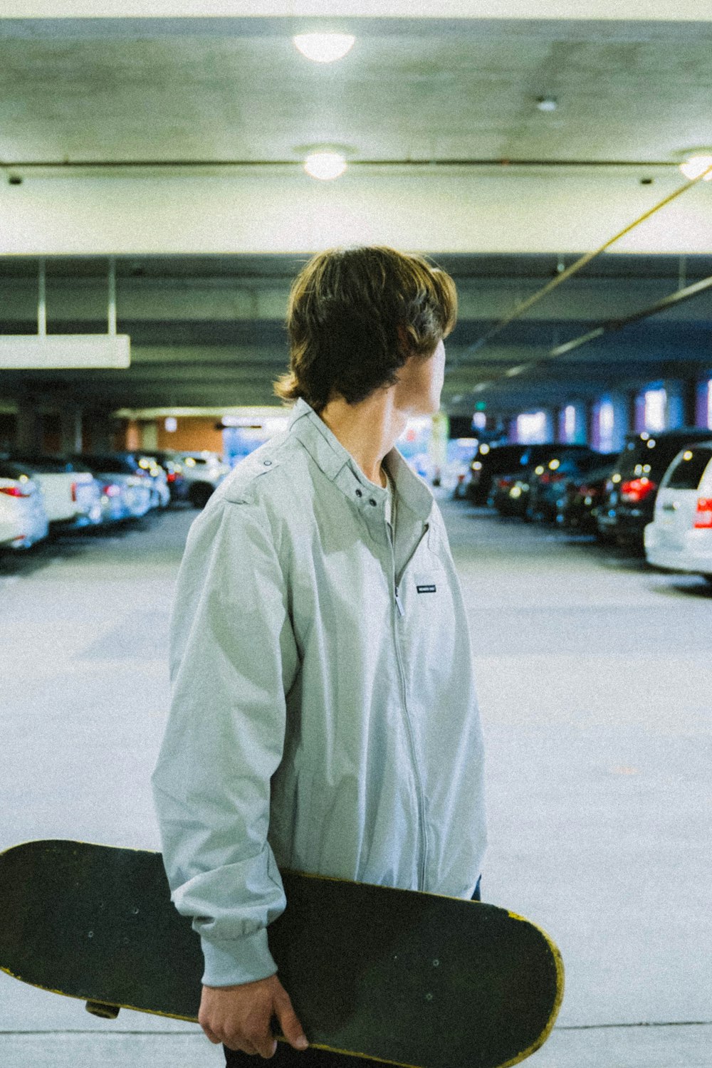 man in white dress shirt standing on parking lot