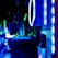 A close-up view of the internal components of a computer, featuring LED lights and cooling fans. The image is lit with blue and green hues, highlighting the sleek, modern design of the hardware.