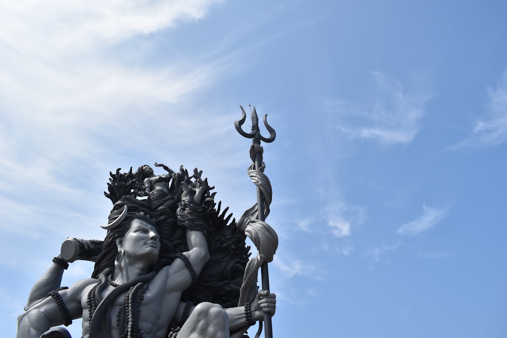 black concrete statue under blue sky during daytime