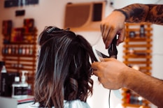 woman in white shirt holding hair blower