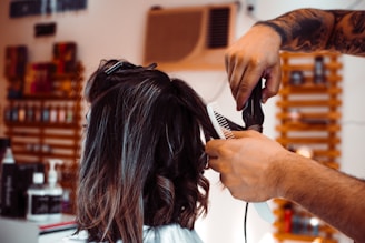 woman in white shirt holding hair blower