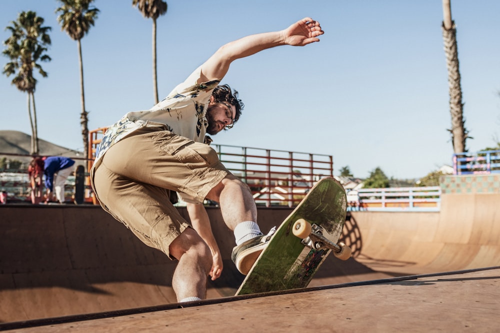 man in brown shorts and black shirt riding skateboard during daytime