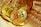 A collection of golden coins featuring the Bitcoin symbol rests inside a woven basket, creating a sense of abundance and wealth.