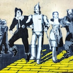 3 men and 2 women standing on yellow brick floor