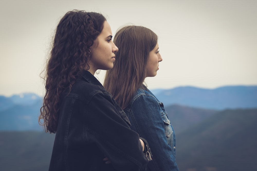 woman in black leather jacket beside woman in blue denim jacket