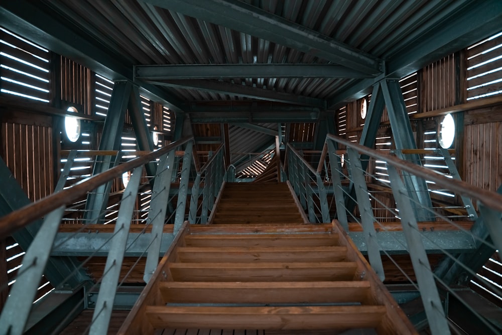 brown wooden stairs with brown wooden railings