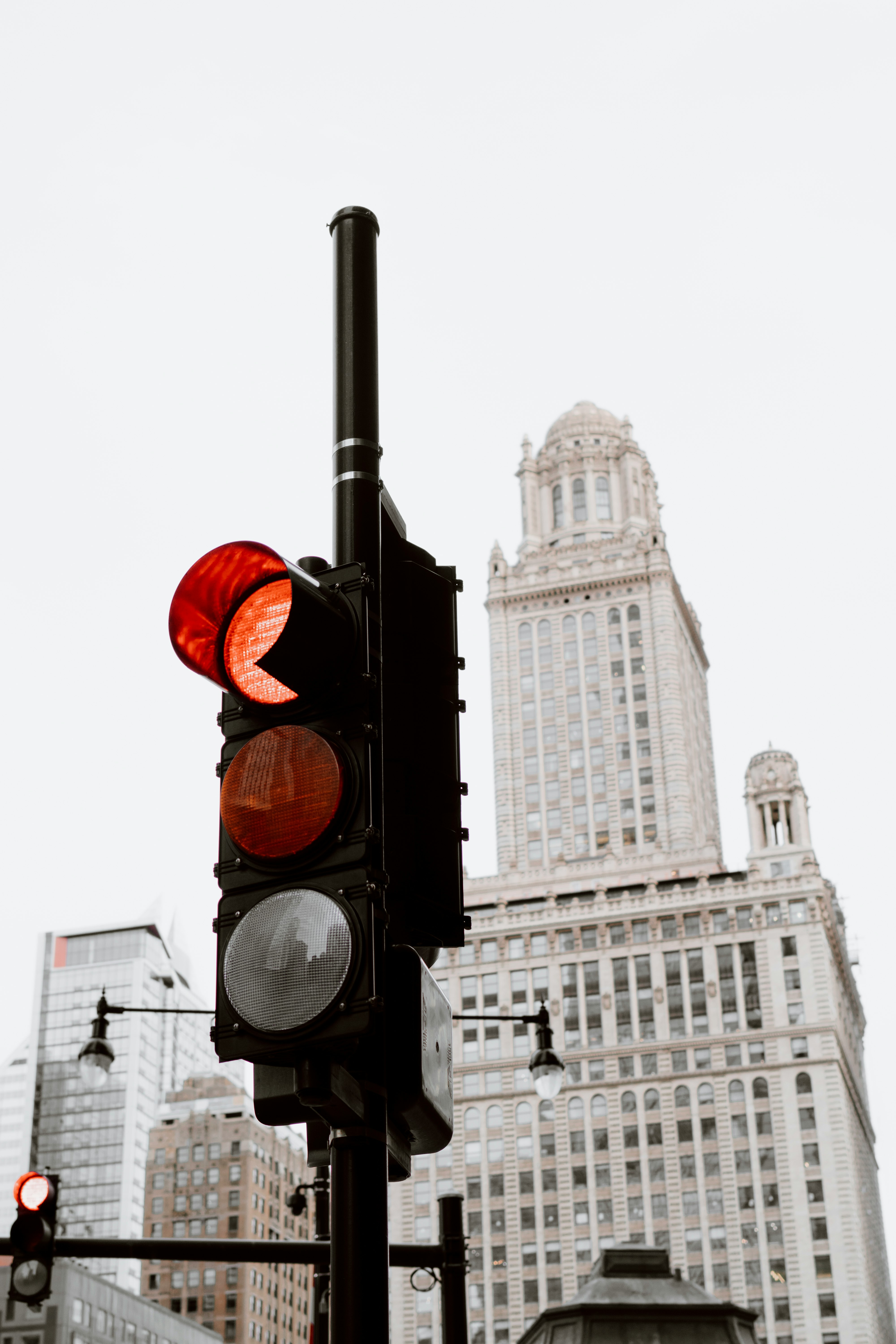 black traffic light near white concrete building during daytime