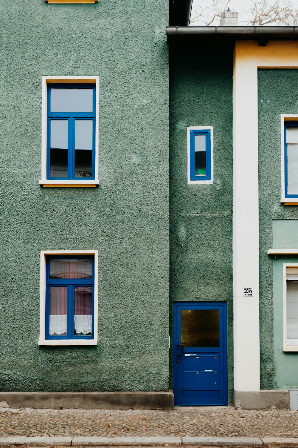 blue wooden door on gray concrete building