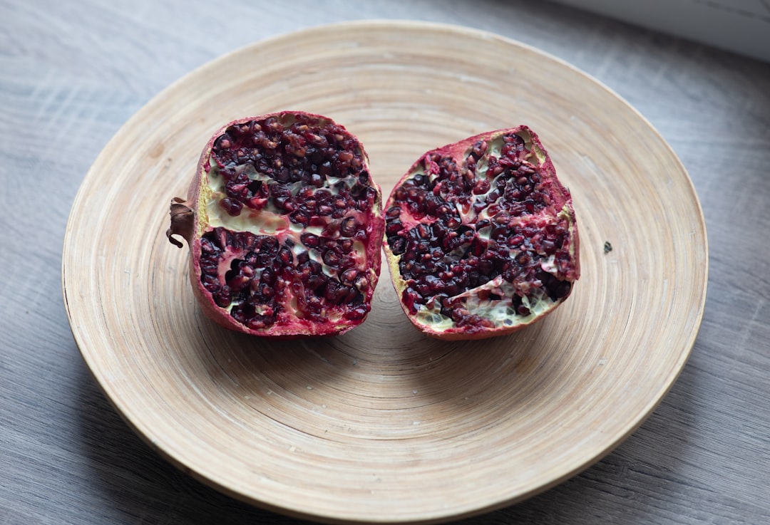 red round fruit on brown wooden round plate