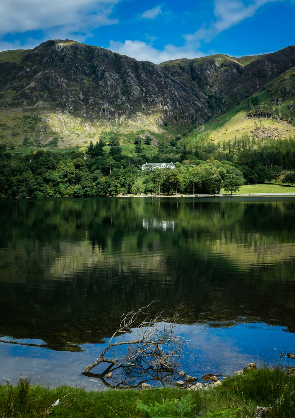 green mountains beside body of water during daytime