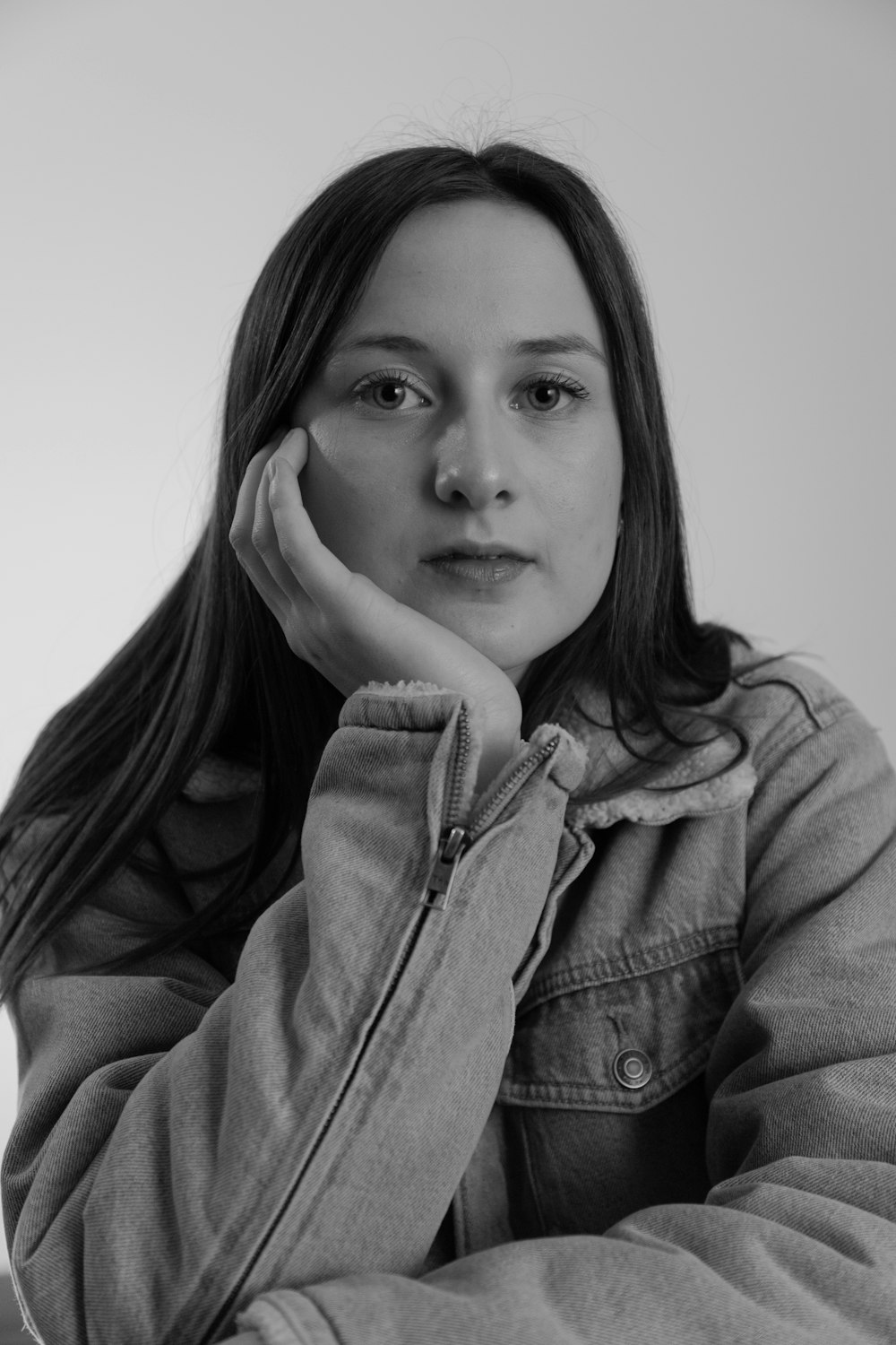 grayscale photo of woman in zip up jacket