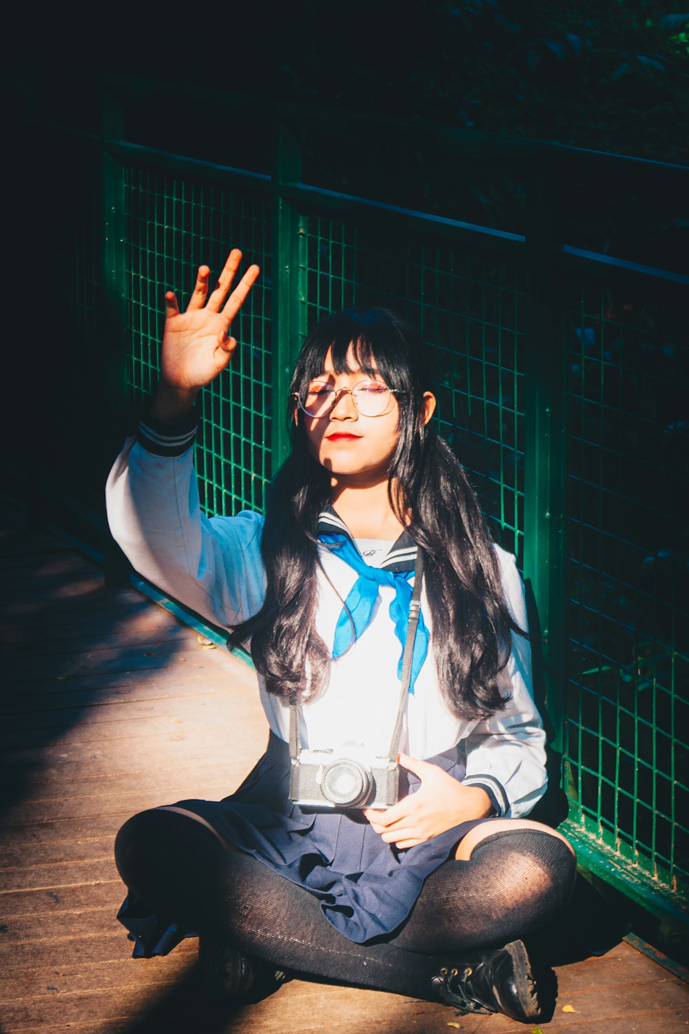 woman in blue jacket and black pants sitting on floor