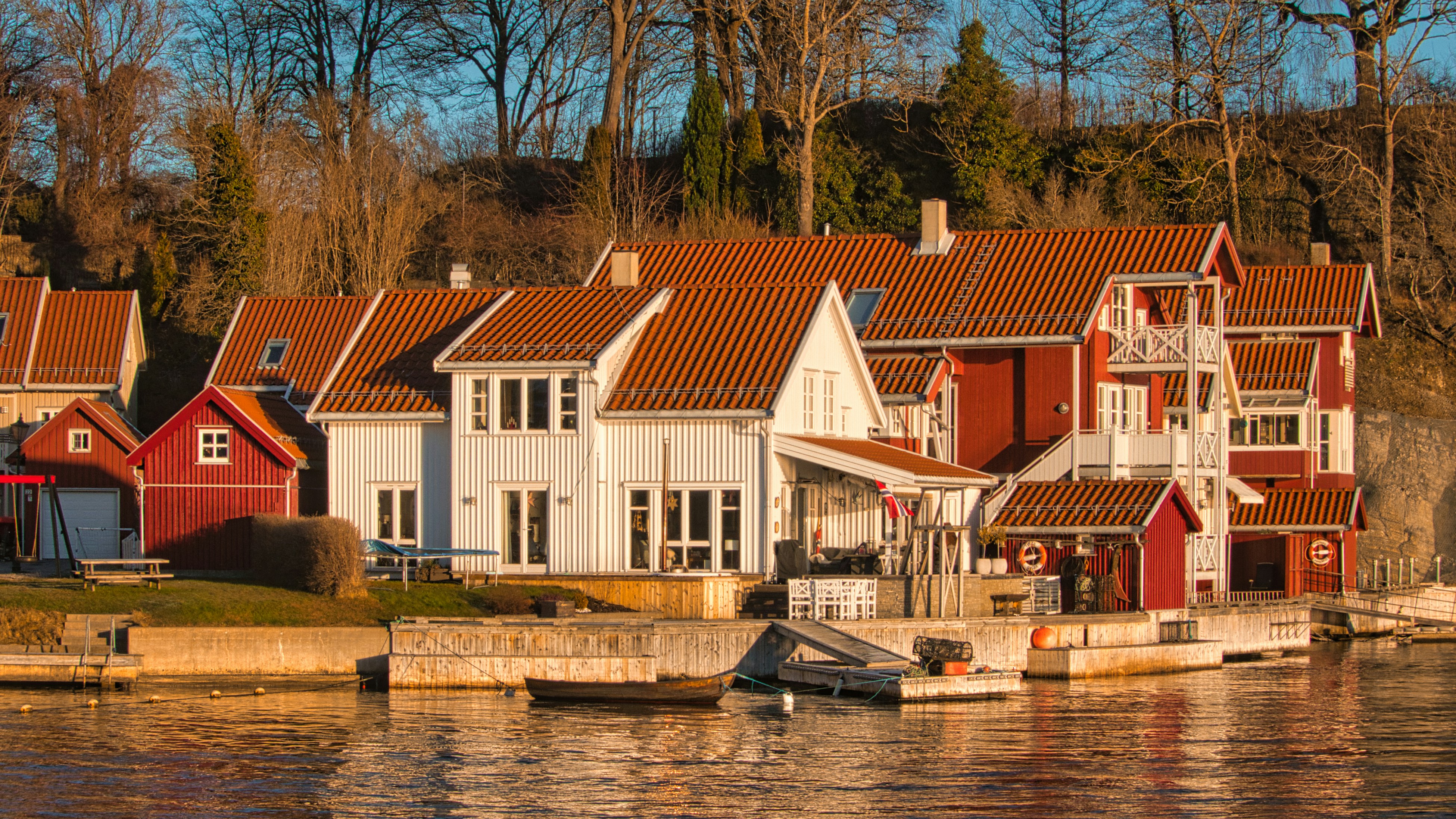 white and brown concrete house beside river during daytime