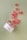 A tipped-over jar labeled 'nora Flavored CBD Gummies' scatters red gummies across a light green surface. The gummies are small, circular, and have a sugar coating.