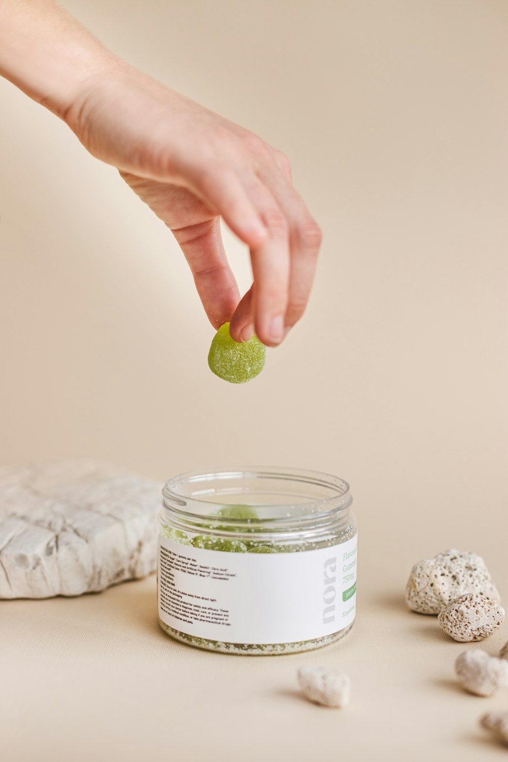 person holding clear glass jar