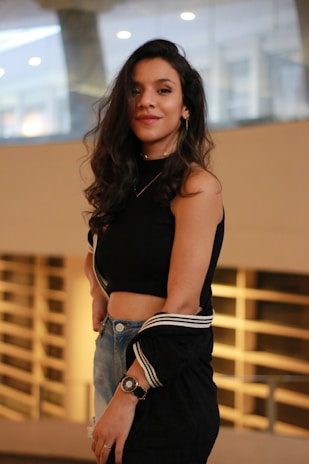 woman in black tank top and blue denim jeans