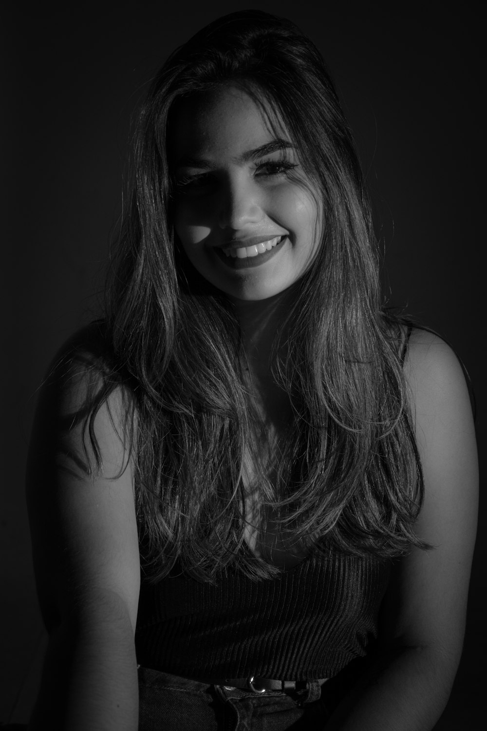 woman in black tank top smiling