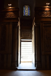 A welcoming preschool entrance with colorful Islamic art and smiling children playing outside.