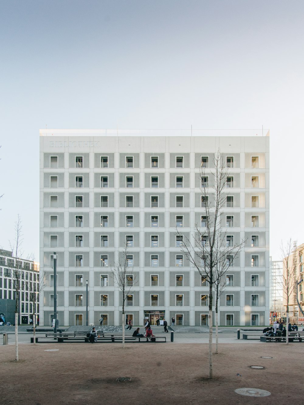 people walking near white concrete building during daytime