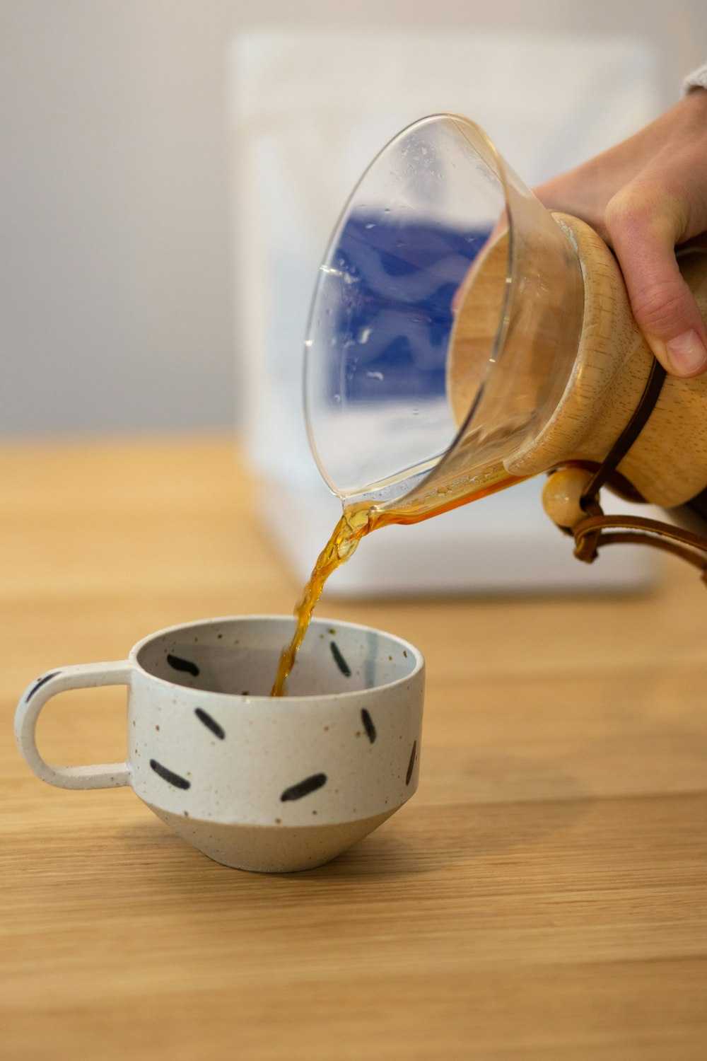 person pouring water on white ceramic mug